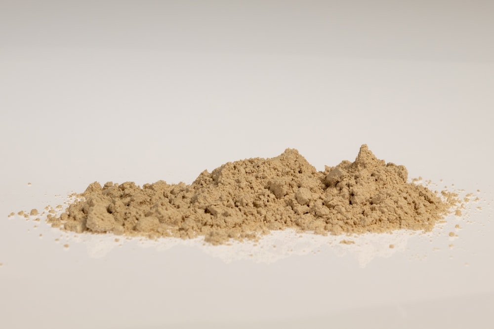 a pile of sand sitting on top of a white table