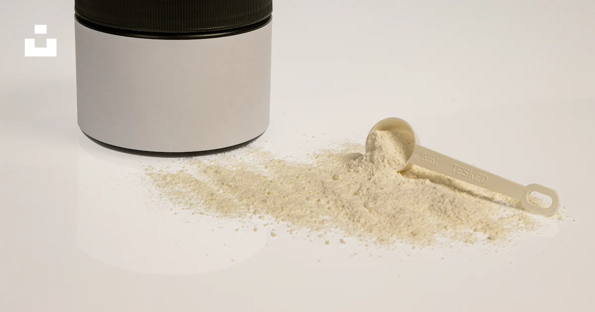 A jar of powder next to a scoop of powder photo – Free Brown Image on ...