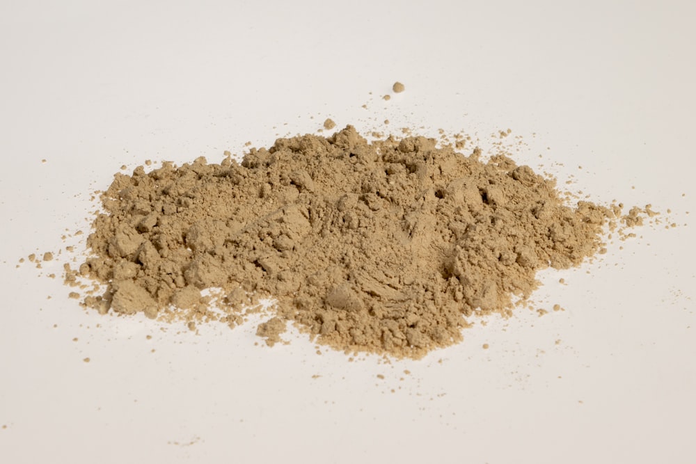 a pile of dirt sitting on top of a white table