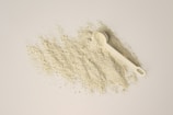 a scoop of powder and a scoop of powder on a white background