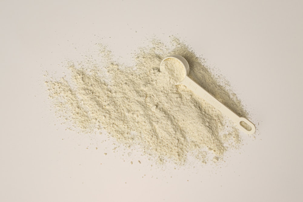 a scoop of powder and a scoop of powder on a white background