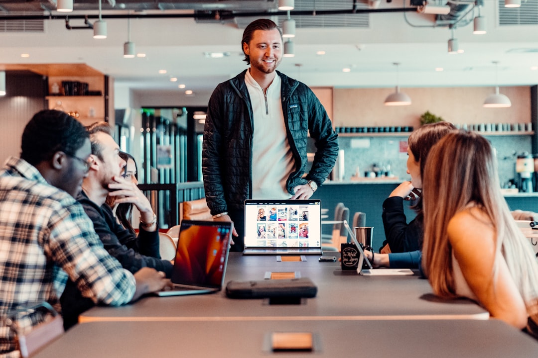 a group of people sitting around a table, Team working in office