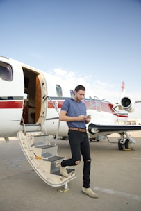 a man standing on the steps of an airplane