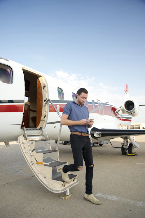 a man standing on the steps of an airplane