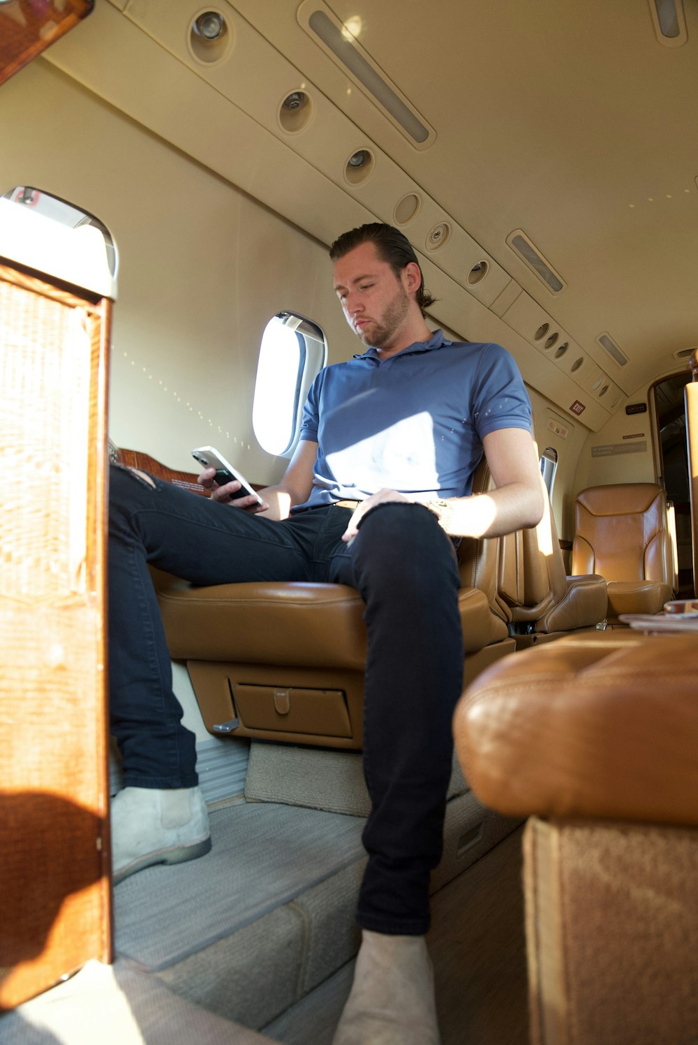 a man sitting on a seat in an airplane