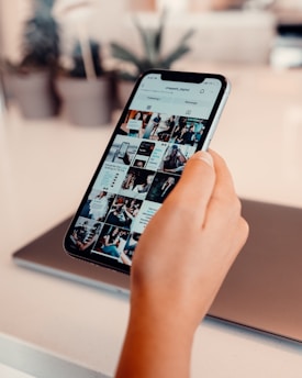 a person using a cell phone on a table