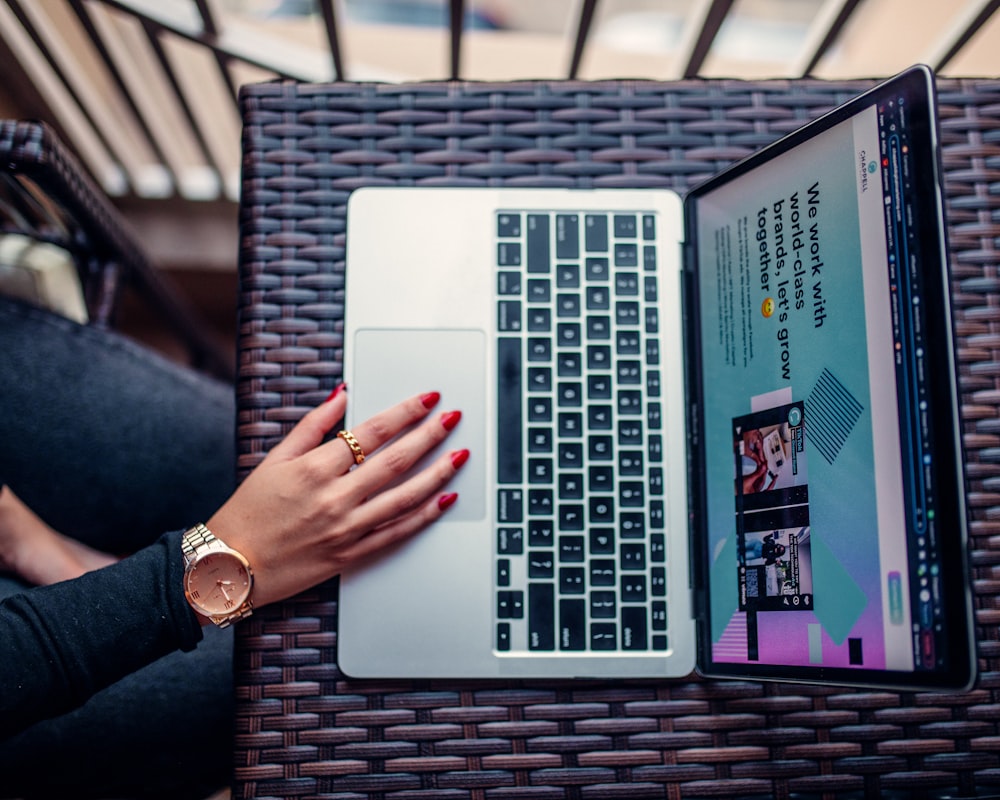 a woman using a laptop computer on a table