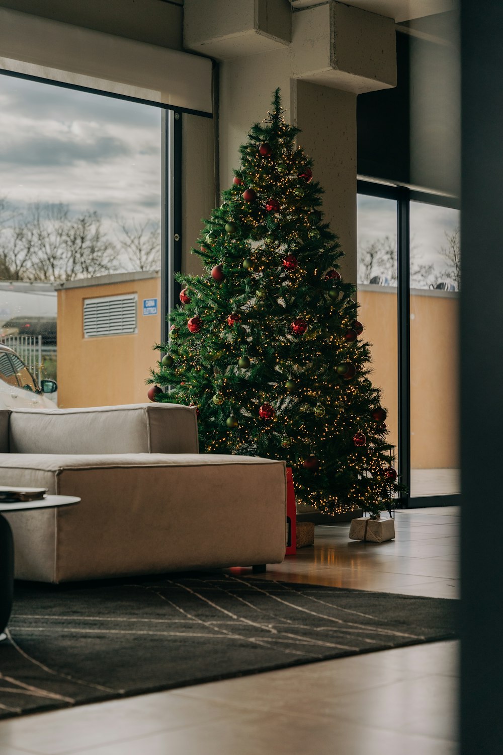 a living room filled with furniture and a christmas tree