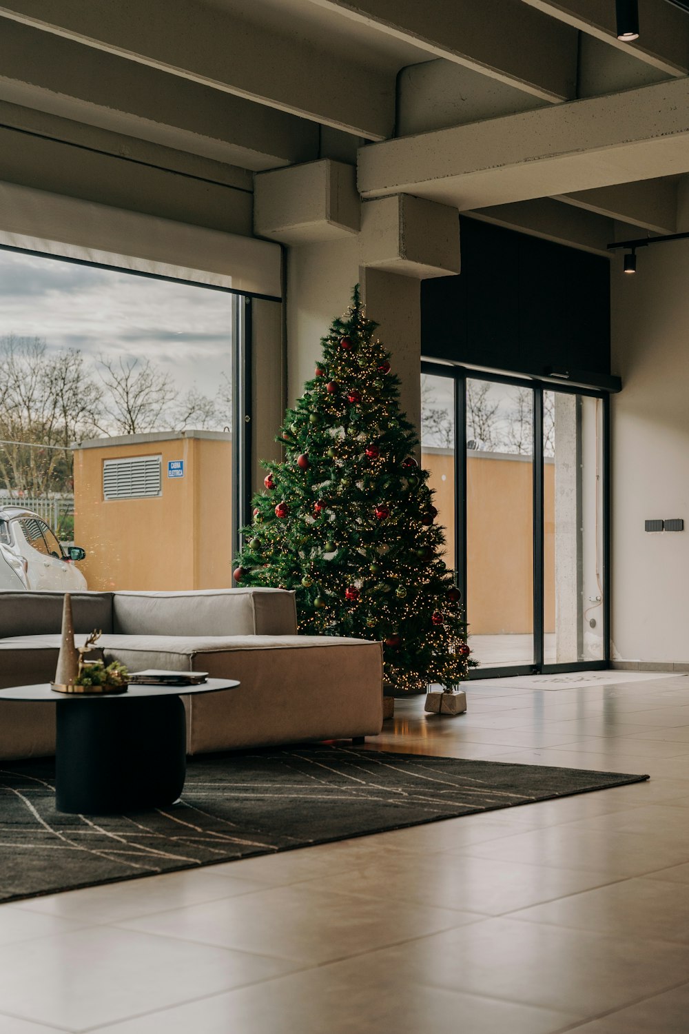 a living room filled with furniture and a christmas tree