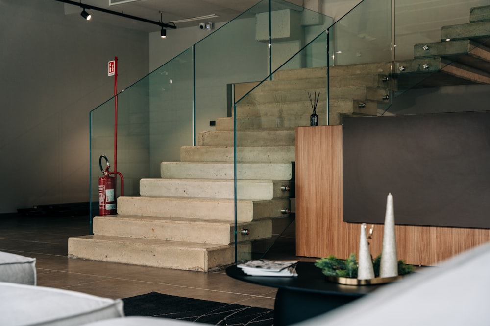 a living room with stairs and a tv