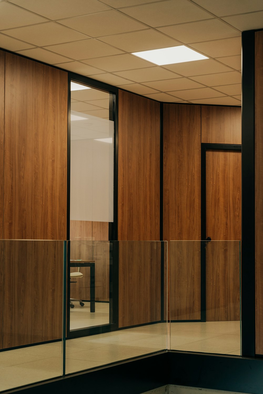 a room with wooden walls and glass doors