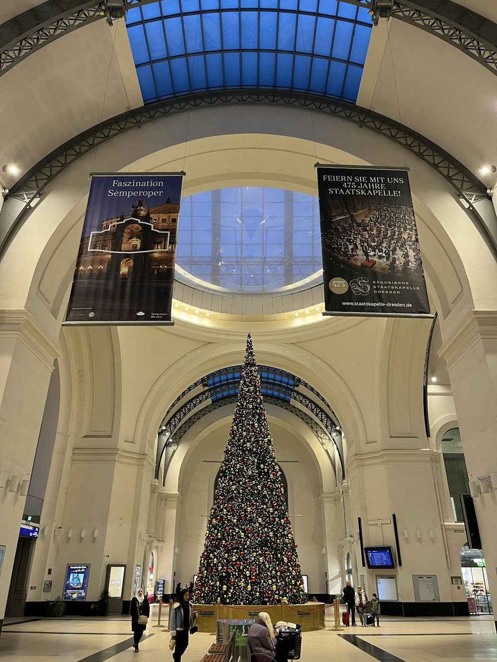 a large christmas tree in a large building