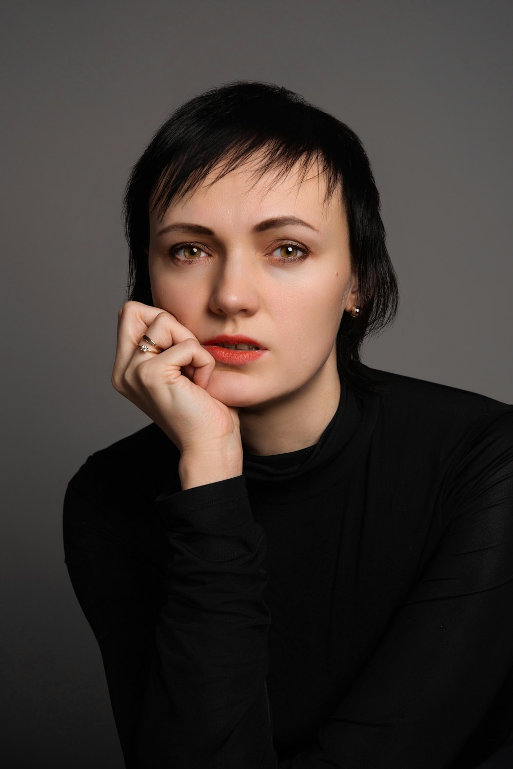 a woman with a black shirt and red lipstick