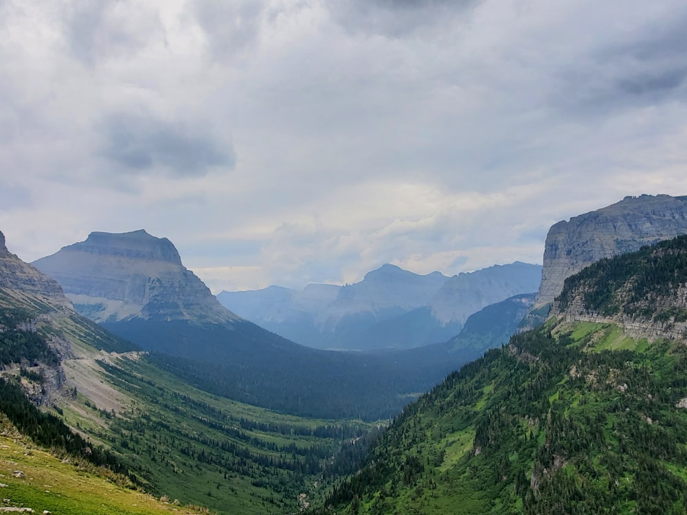 a view of a valley with mountains in the background