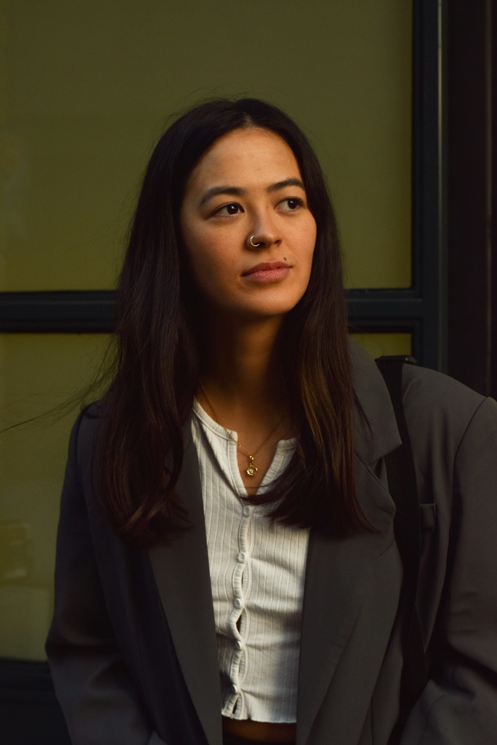 a woman in a black jacket and white shirt