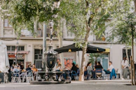 a group of people sitting at a table under an umbrella