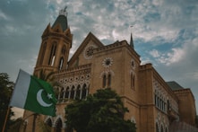 a large building with a flag in front of it