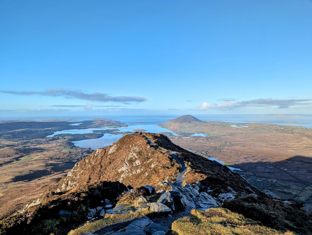 a view from the top of a mountain looking down at a lake