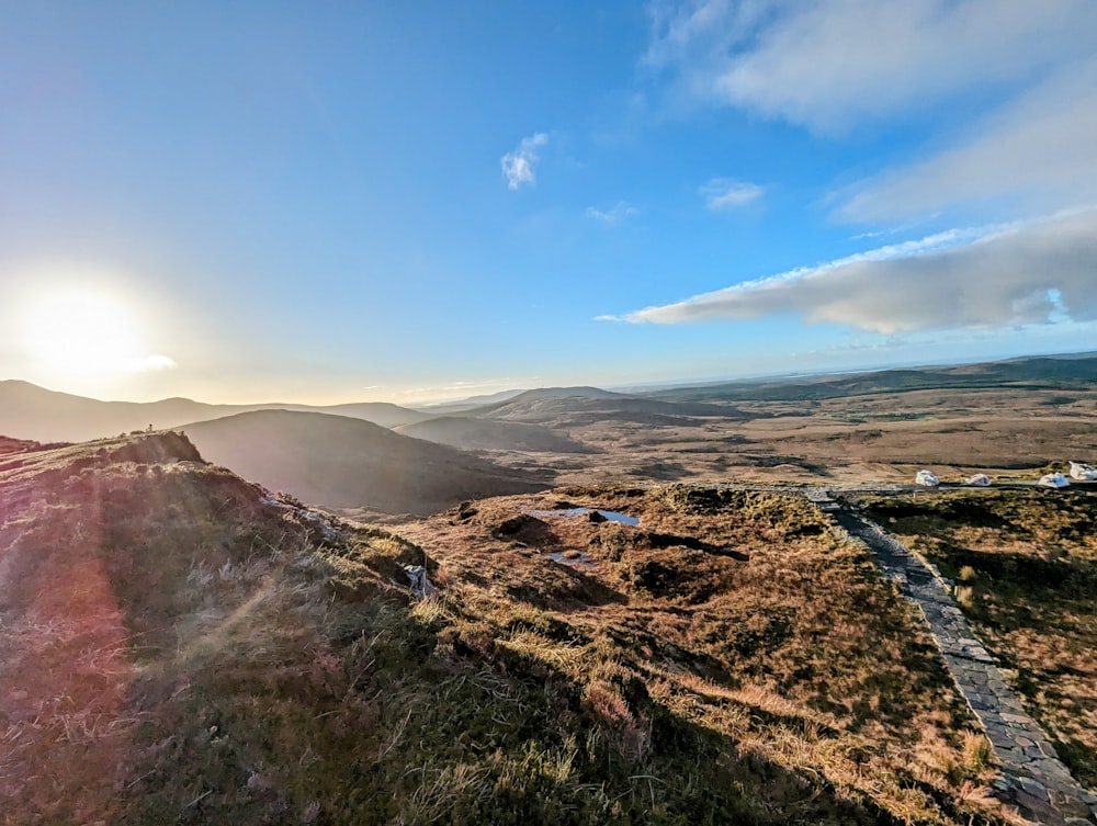 the sun is shining over a mountain range