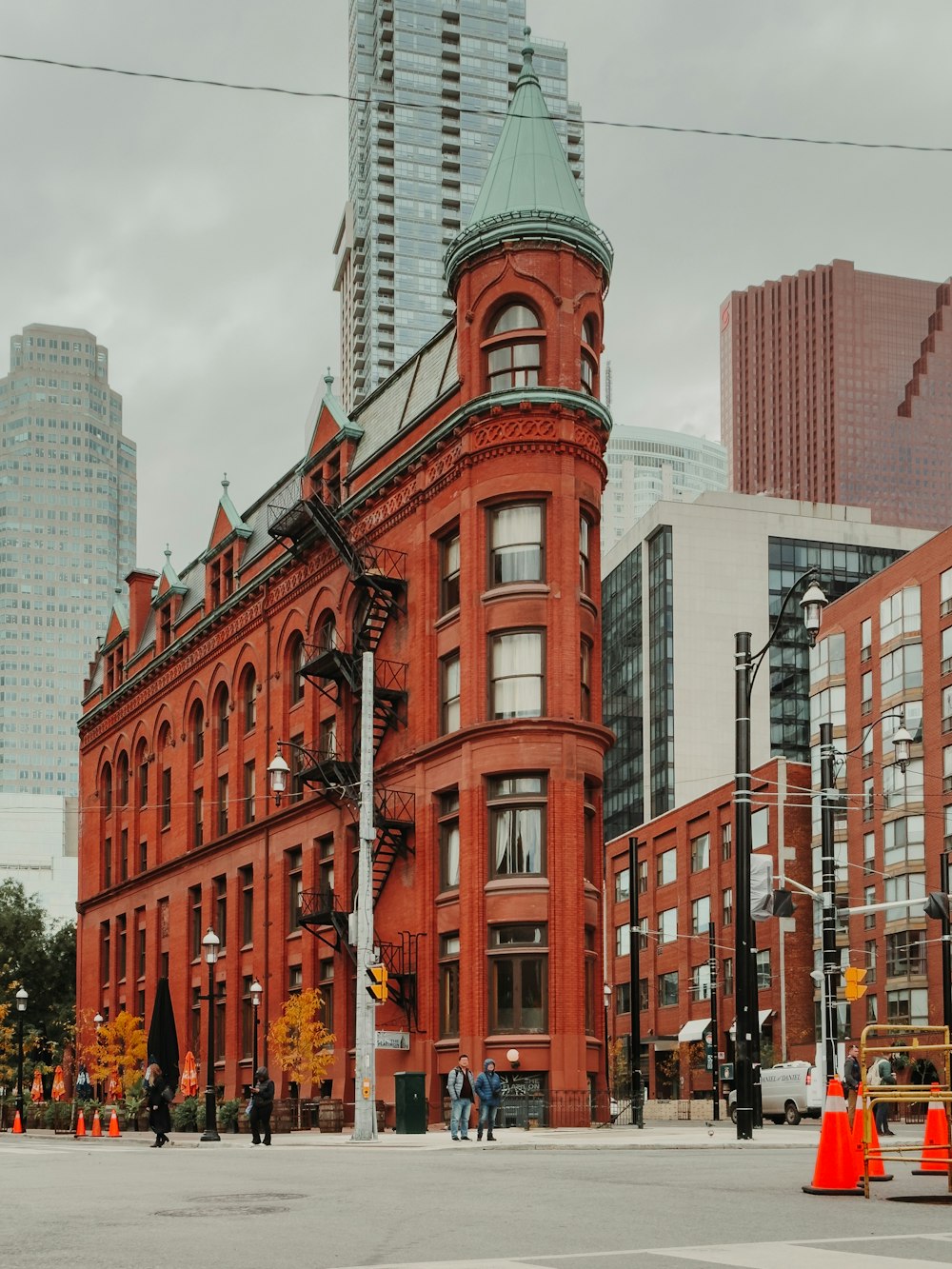 a red brick building with a green steeple on top