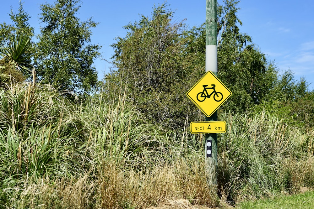 a yellow sign with a bicycle on it