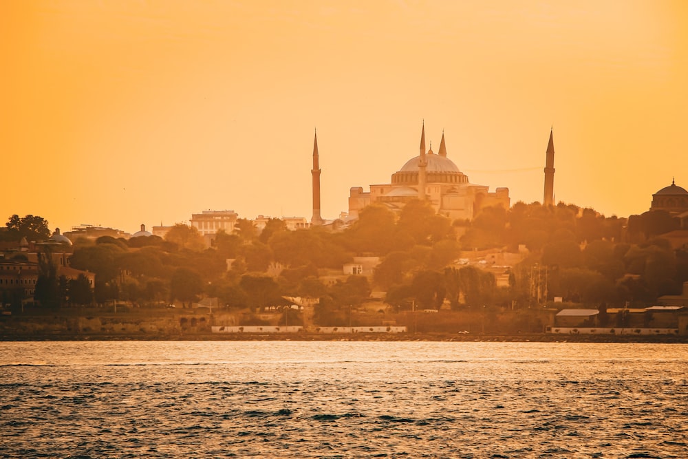 a large body of water with a city in the background