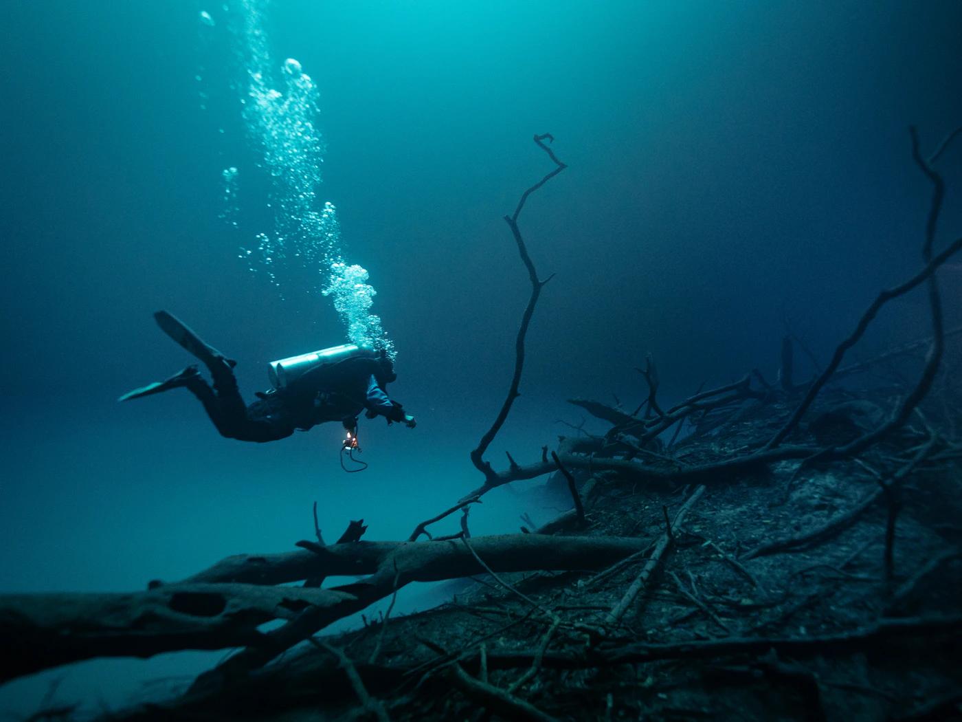 Scuba diver exploring deep blue water