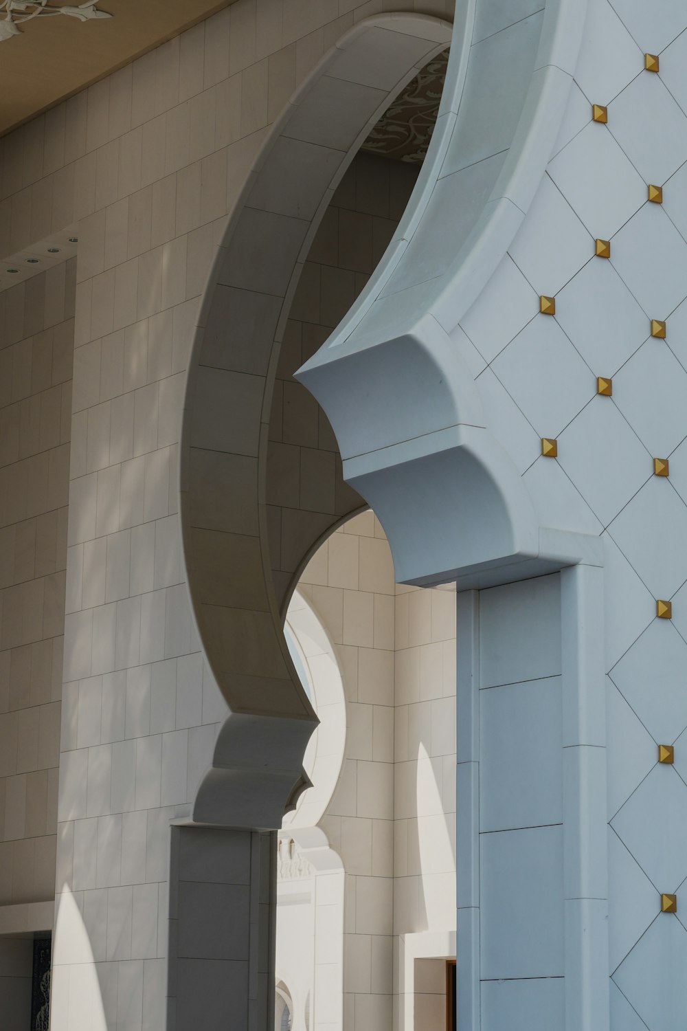 a white building with gold details on the side of it