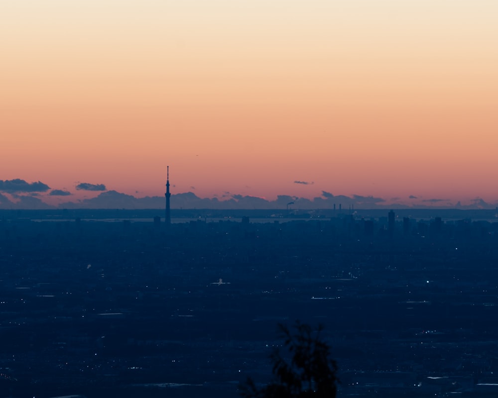 a view of a city at sunset from the top of a hill