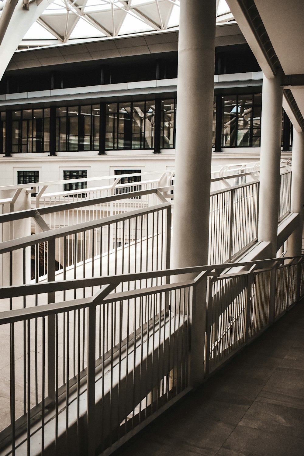 a person walking down a walkway next to a building