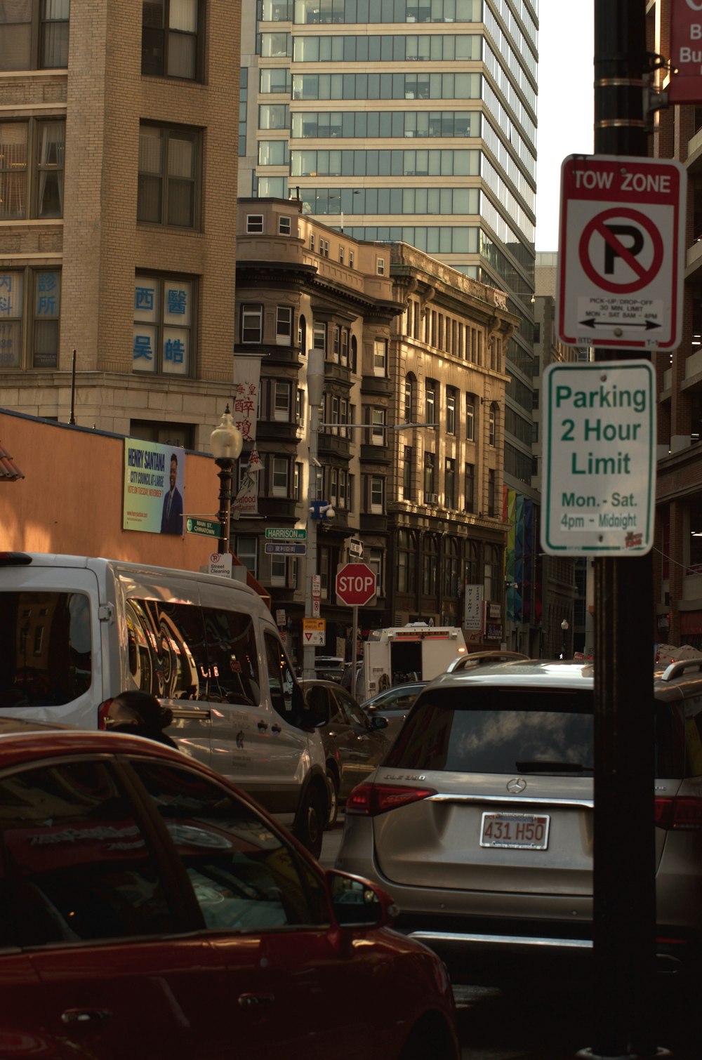 a street filled with lots of traffic next to tall buildings