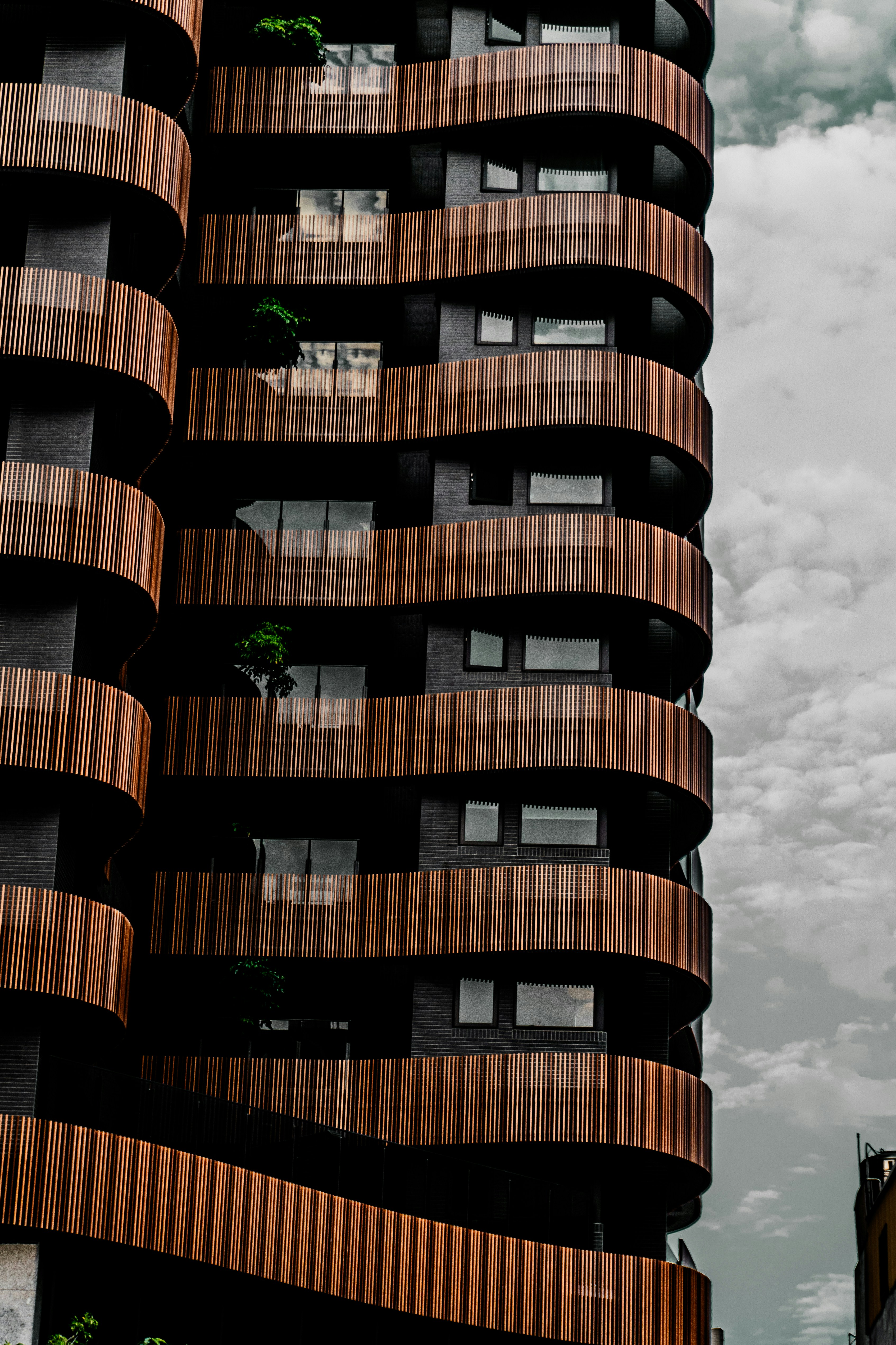 a very tall building with wooden balconies on it