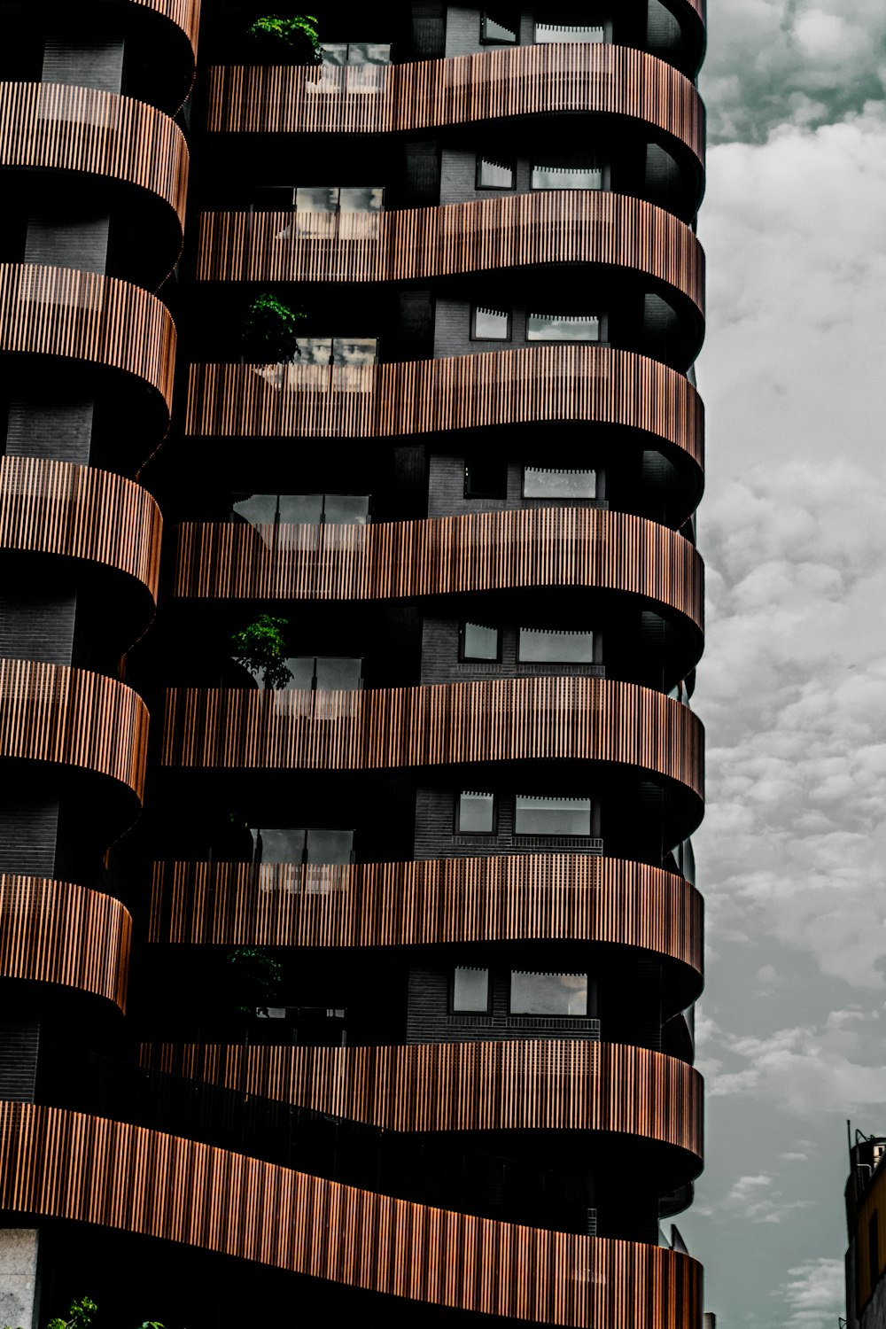 a very tall building with wooden balconies on it