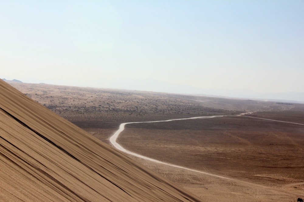 a person riding a motorcycle down a dirt hill