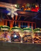a row of glass jars filled with different types of food