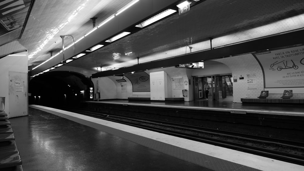 a black and white photo of a train station