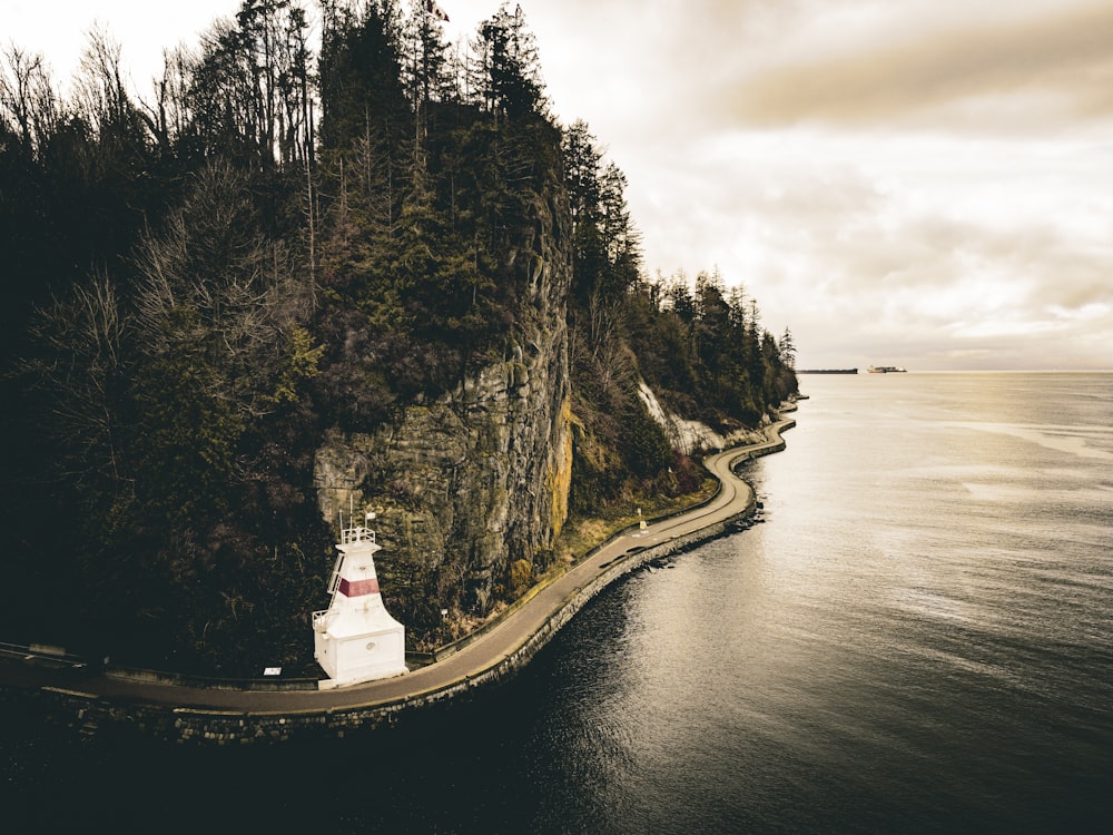 a lighthouse on an island in the middle of the ocean