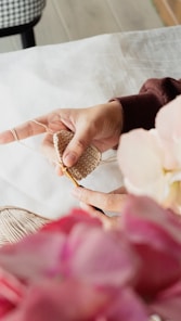 a woman is holding a piece of bread in her hand