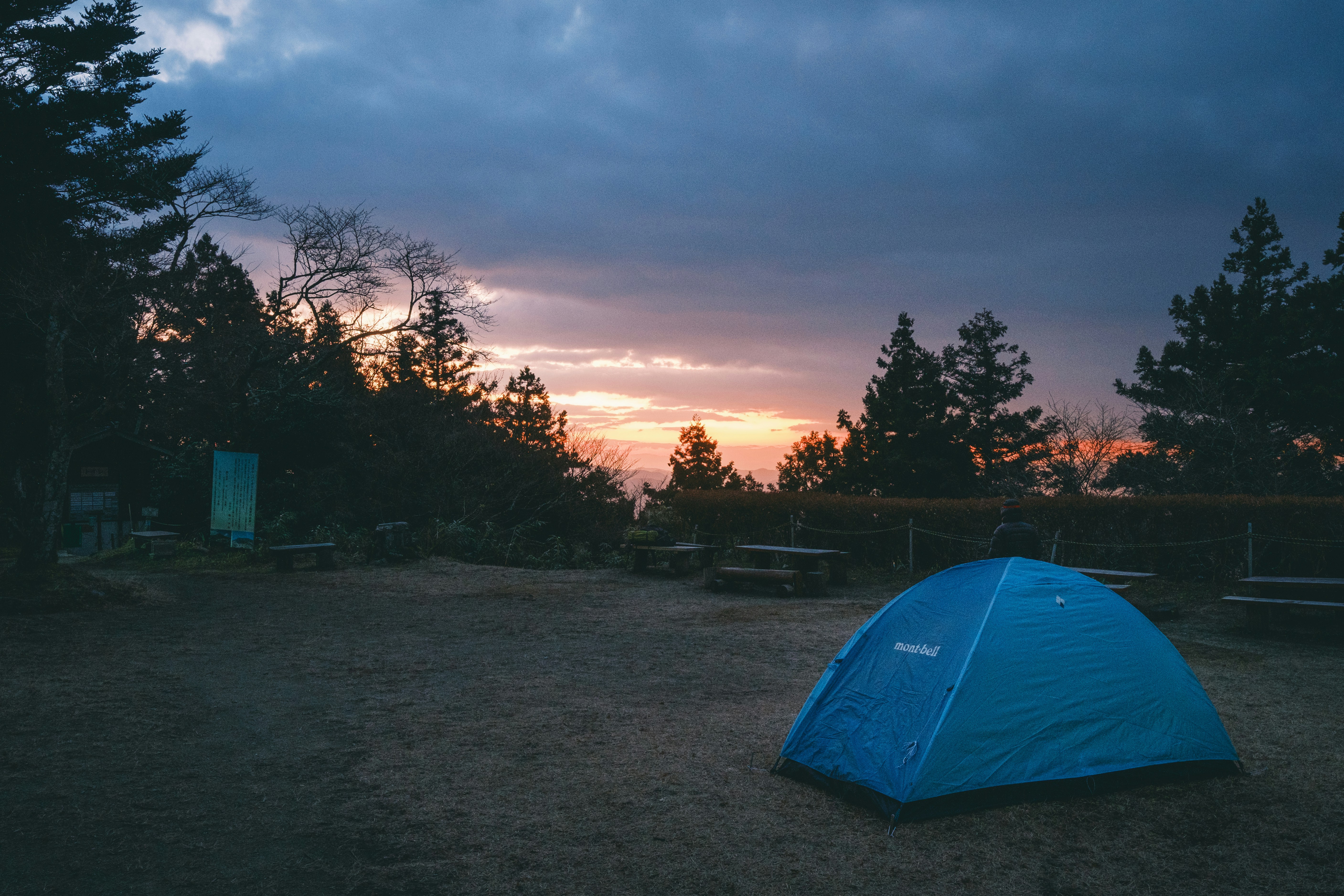 Stop image for Portland to Crater Lake: 3-Day Nature Adventure - a blue tent sitting in the middle of a field -  in Pacific Northwest & West Coast - Photo by Nichika Sakurai on Unsplash