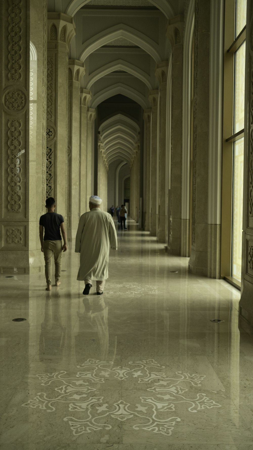 a man and a woman walking down a hallway