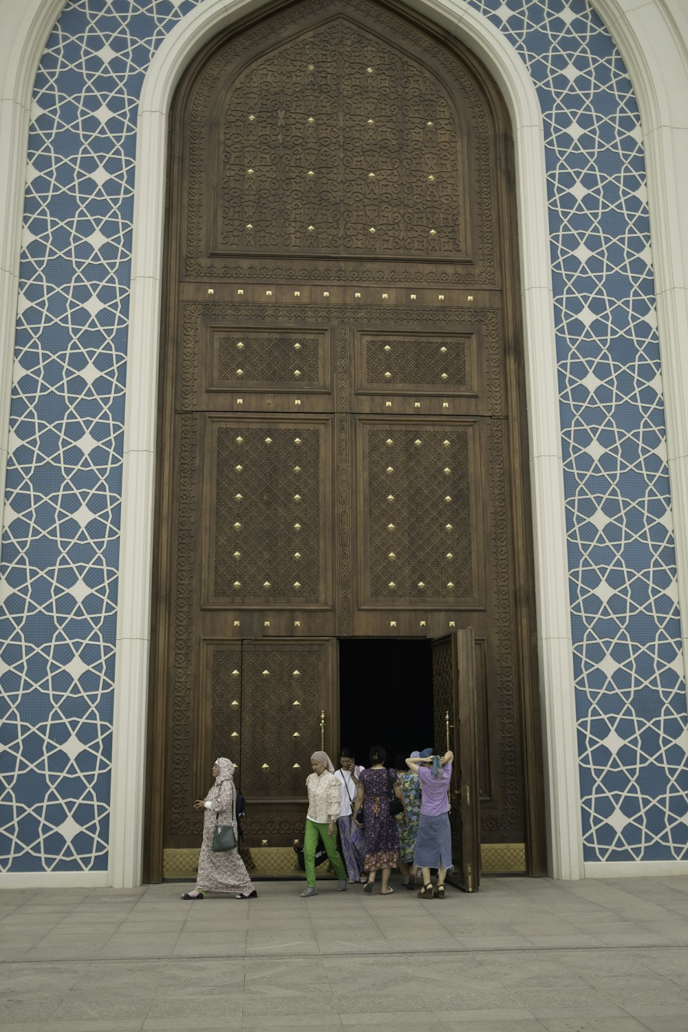 a group of people standing in front of a large door