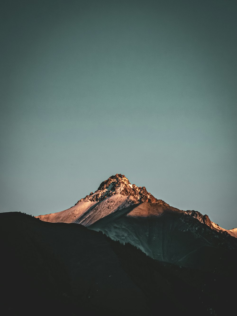 a snow covered mountain with a sky background