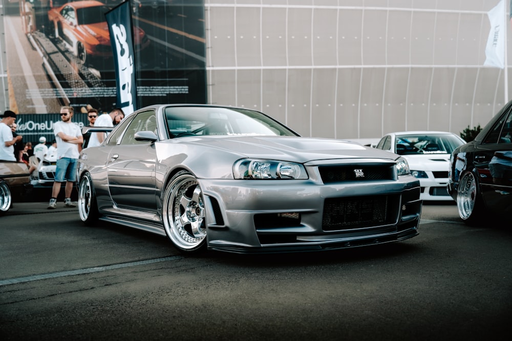 a silver car parked in front of a building