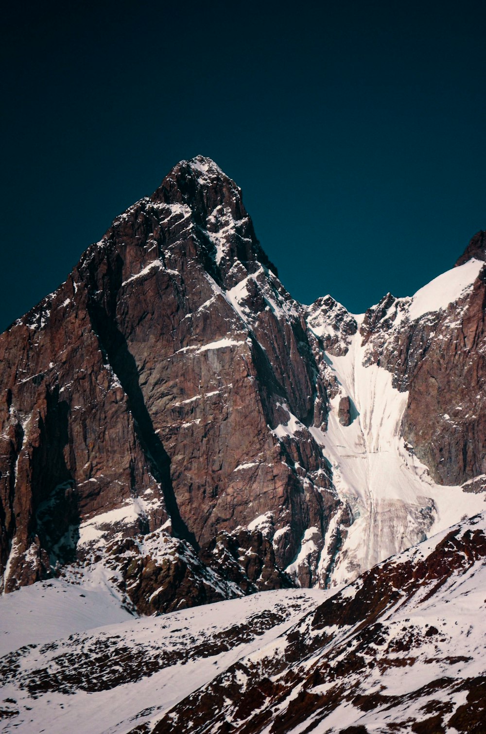 a snow covered mountain with a clear blue sky