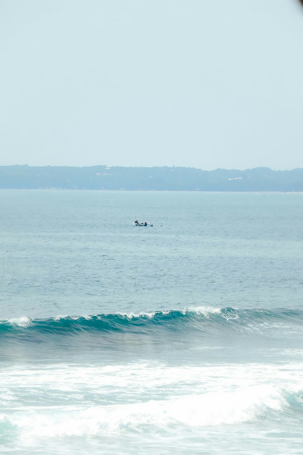 a person riding a surfboard on a wave in the ocean