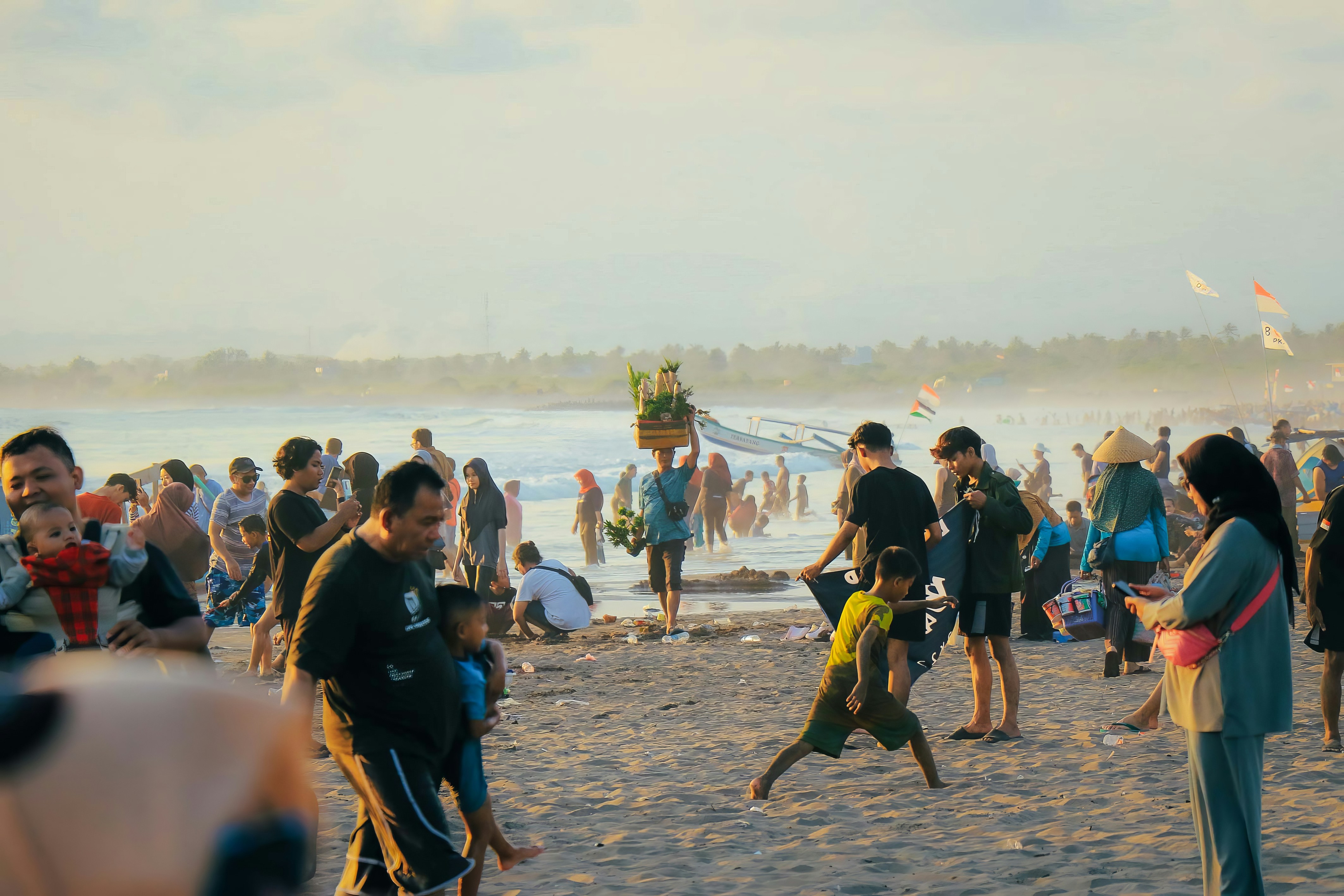 a group of people standing on top of a sandy beach