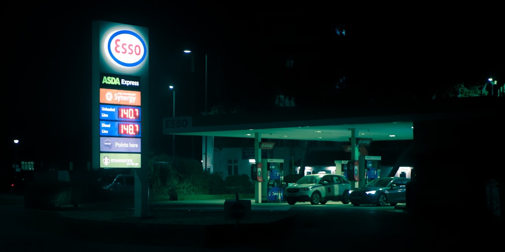 a gas station sign lit up at night