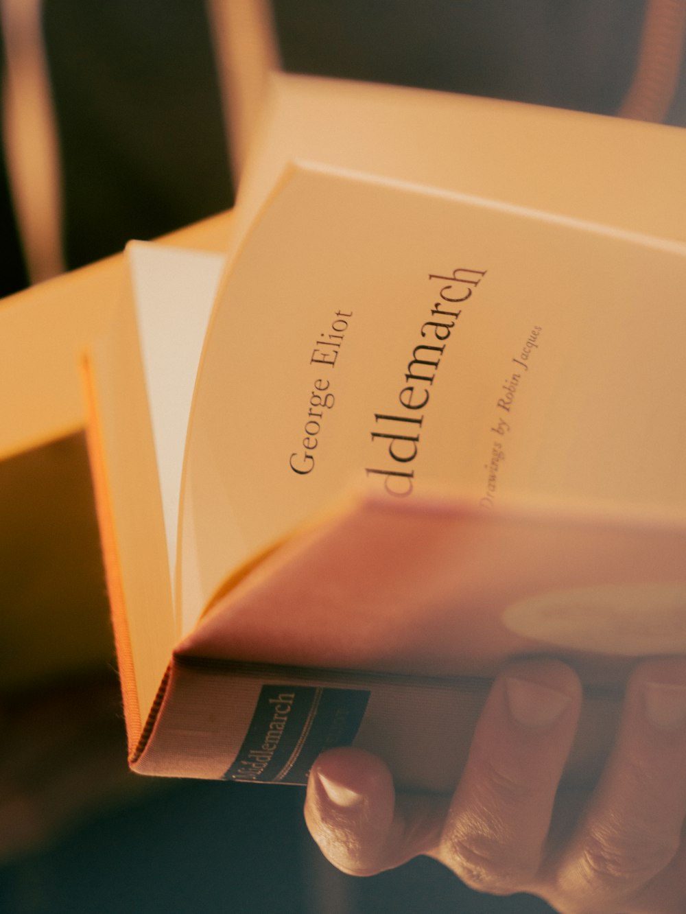 a close up of a person holding a book