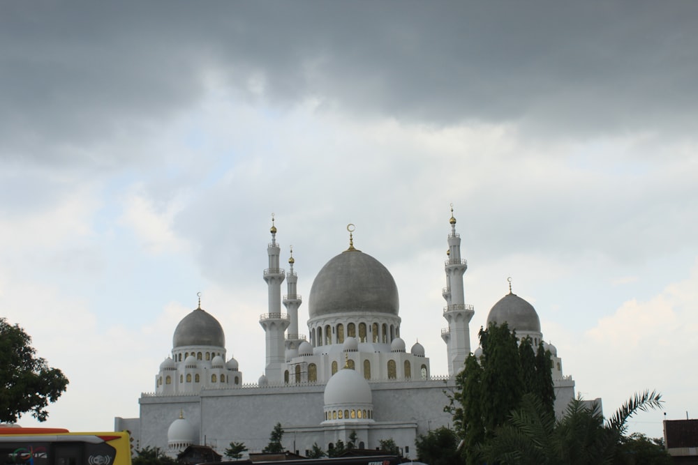 a large white building with two domes on top of it