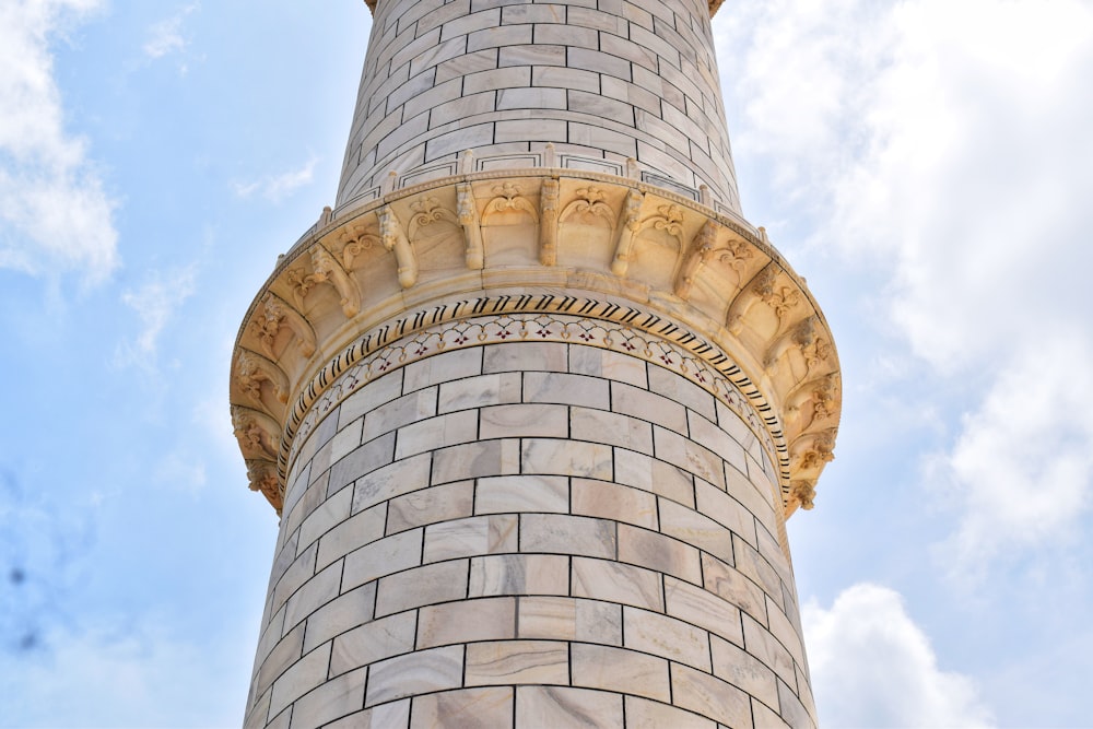 a tall brick tower with a clock on the top